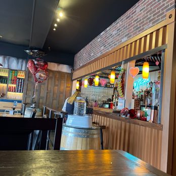 Soi 705 - a bar with a wooden table and chairs - Thai Near Me - Richland, Washington