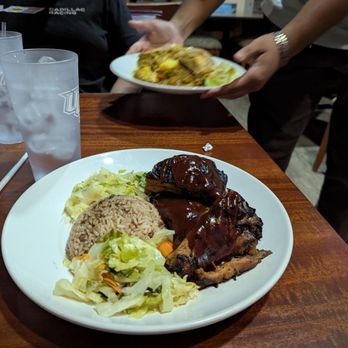 Mark's Jamaican Bar and Grill - Large portion of BBQ jerk chicken with rice and peas, and double lettuce. 16 dollars - Caribbean Near Me - Orlando, Florida Mark's Jamaican Bar and Grill - Large portion of BBQ jerk chicken with rice and peas, and double lettuce. 16 dollars - Caribbean Near Me - Orlando, Florida