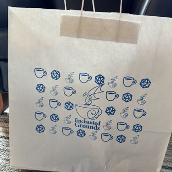 Enchanted Grounds - Bag of goodies I walked out of the shop with (two board games and a dragon to take home and paint) - Coffee & Tea Near Me - Highlands Ranch, Colorado