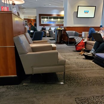 Delta Sky Club - people sitting in lounge chairs - Airport Lounges Near Me - Tampa, Florida