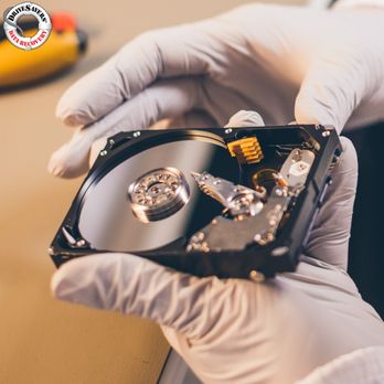DriveSavers Data Recovery - Delicate Hands, Critical Data - Careful inspection of a hard drive to retrieve lost information. - Data Recovery Near Me - Novato, California