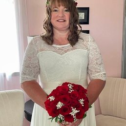 This is me on my wedding day with the beautiful rose bouquet and floral headband that were made by Evergreen Florist.