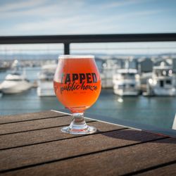 A tulip glass on the patio overlooking the marina