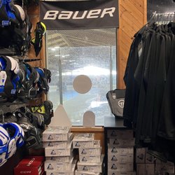 Ice Box Hockey - View of the attached rink out the back, and racks of gear on display