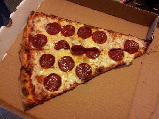 Photo of A Town Pizza & Kabob House - San Ramon, CA, US. Slice of Pizza to go. The picture doesn't do it's actual size any justice. This sucker was HUGE...