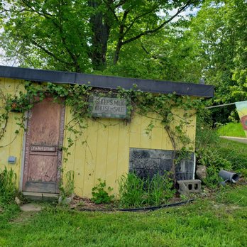 Vermont Shepherd - a yellow shed with sunflowers on it - Cheese Shops Near Me - Putney, Vermont