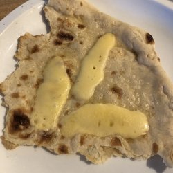 Mediterranean Food Imports & Bakery 2 - A bit of the massive flat bread we bought with some cheese on it. That's maybe 1/4 of one piece and that's a full-sized dinner plate!