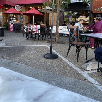 Carmen's Bistro & Bar - a woman sitting at a table - Bars Near Me - Santa Rosa, California