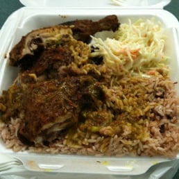 Jerk chicken with curry duck sauce, w/ coleslaw and rice and peas