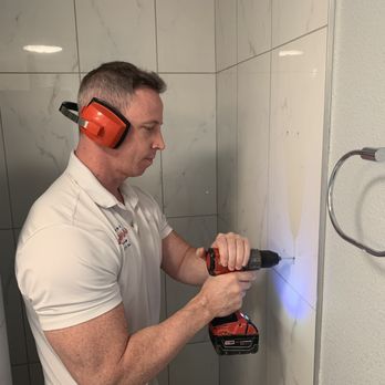 Superior Safety Bars - a man using a drill to fix a shower - General Contractors Near Me - Sarasota, Florida Superior Safety Bars - a man using a drill to fix a shower - General Contractors Near Me - Sarasota, Florida