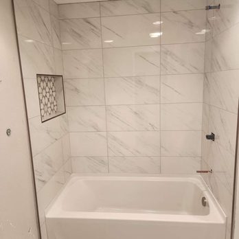 Ruano Construction - a bathtub and shower in a bathroom - General Contractors Near Me - Everett, Washington Ruano Construction - a bathtub and shower in a bathroom - General Contractors Near Me - Everett, Washington