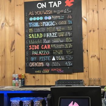 Ledge Brewing Company - Menu - A black chalkboard menu displays various craft beers with names, descriptions, and alcohol percentages at a brewery, mounted on a wooden wall. - Breweries Near Me - Intervale, New Hampshire