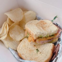 a sandwich and chips in a basket a sandwich and chips in a basket