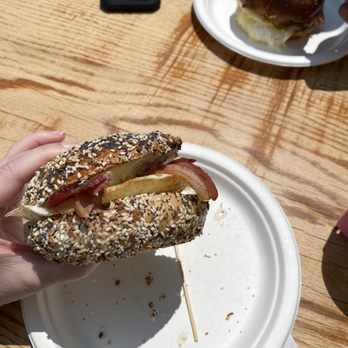The Green Room - a person holding a sandwich on a paper plate - Juice Bars & Smoothies Near Me - Hampton, New Hampshire The Green Room - a person holding a sandwich on a paper plate - Juice Bars & Smoothies Near Me - Hampton, New Hampshire