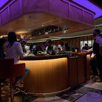 Georgie - a group of people sitting at a bar - New American Near Me - Dallas, Texas