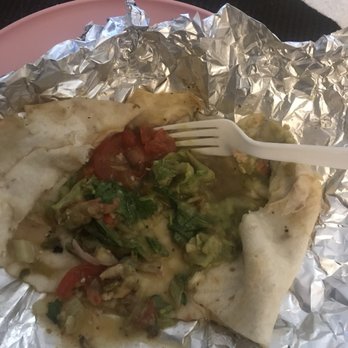 Java Joe's - Soggy wrap - A burrito with vegetables and salsa, partially eaten, resting on crumpled aluminum foil, with a plastic fork inserted into it. - Coffee & Tea Near Me - Albuquerque, New Mexico