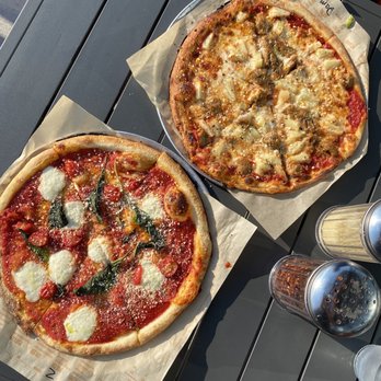 Blaze Pizza - two pizzas on a table - Salad Near Me - Bismarck, North Dakota