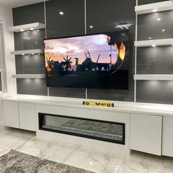 iMount TV - 85" TV mounted above a fireplace in maple Ridge house.
