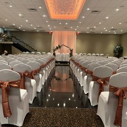 The Fez Extraordinary Events - Balconade Room setup for wedding ceremony, featuring white chair covers and terracotta sashes