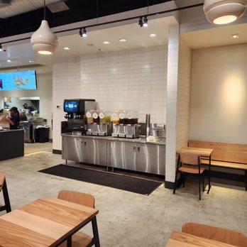CAVA - a restaurant with tables and benches - Salad Near Me - Jacksonville, Florida