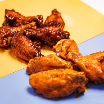 Atomic Wings - BedStuy - a plate of chicken wings on a yellow and blue plate - Chicken Wings Near Me - Brooklyn, New York