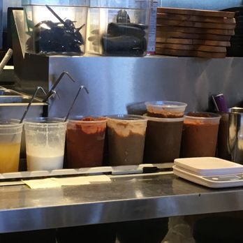 DOMU - An impressive line-up of sauces & condiments in the busy open kitchen. - Ramen Near Me - Jacksonville, Florida