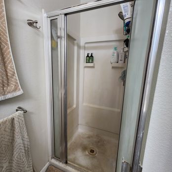 Shower Mama - Before: Old, corroded door, outdated frame, mildew/discolored pan and walls - General Contractors Near Me