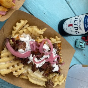Bouldin Acres - Waffle fries with brisket, topped with pickled vegetables, sour cream and cream cheese, and queso! - Barbeque Near Me - Austin, Texas Bouldin Acres - Waffle fries with brisket, topped with pickled vegetables, sour cream and cream cheese, and queso! - Barbeque Near Me - Austin, Texas