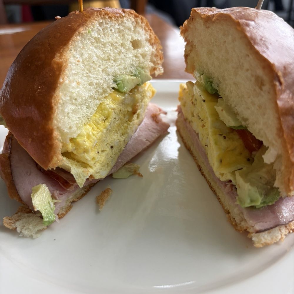 Egg, ham, cheese, avocado, tomato on brioche bun Egg, ham, cheese, avocado, tomato on brioche bun