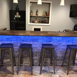 A3B Renovations - Custom bar made along with flooring, recessed shelving and bar fridge.