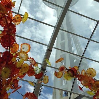 Space Needle - Thru the Chihuly greenhouse roof. - Landmarks & Historical Buildings Near Me - Seattle, Washington Space Needle - Thru the Chihuly greenhouse roof. - Landmarks & Historical Buildings Near Me - Seattle, Washington
