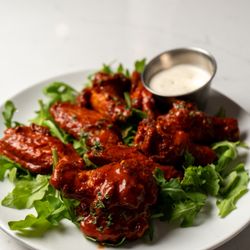 Florenza - Chicken wings with greens and dipping sauce at Florenza.