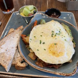 Skillet w bacon, avocado, breakfast potatoes, and cheese.