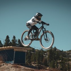 Snow Valley Mountain Resort - A MTB Rider at Snow Valley jumping off a wooden terrain park feature.