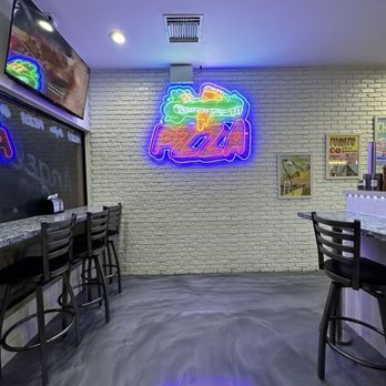PZZA& : Boca Raton - a neon sign in a restaurant - Pizza Near Me - Boca Raton, Florida