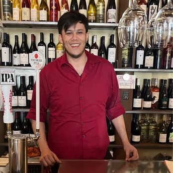 Himalayan Sherpa Kitchen - Cameron in front of a well stocked bar at Himalayan Sherpa - Himalayan/Nepalese Near Me - St. Helena, California
