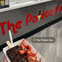 Coconut paleta dipped in Oreo with strawberries