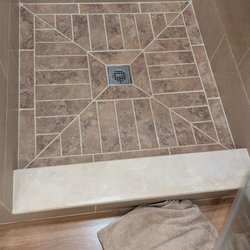 SST Construction - Bathroom transformation featuring new tile, cabinetry, and upgraded fixtures.