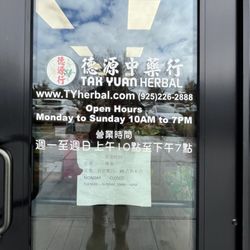 Tak Yuan Herbal - Door showing hours, website, and phone number.