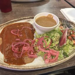 Vegan bean enchiladas with guacamole salad which