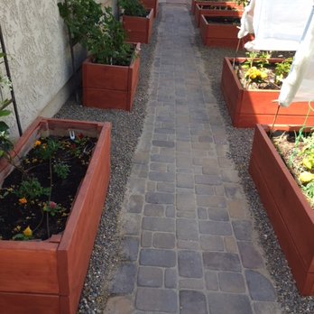Eco Landscape - a narrow walkway with raised planters - Landscaping Near Me