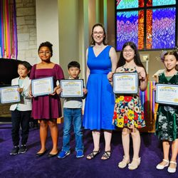 Pfluger Rock School of Music - Pfluger Rock students with teacher at piano recital.