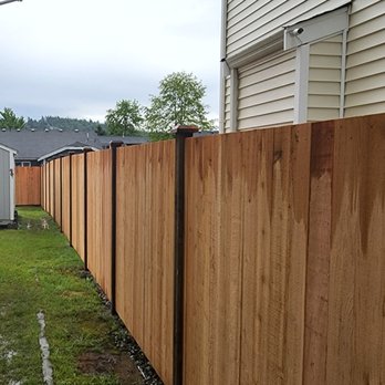 RK Fencing & Construction - a wooden fence in a residential area - General Contractors Near Me