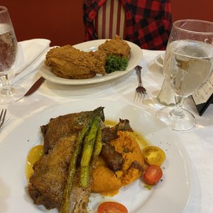 Photo of Dooky Chase's Restaurant - New Orleans, LA, United States. Fried chicken diner and seared duck with sweet potato soufflé and asparagus.