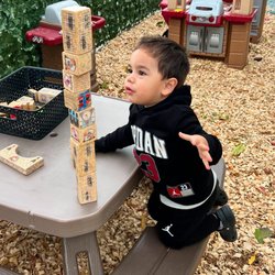 Sunshine House Preschool - Hands-on STEM discovery! Outdoor block play encourages spatial reasoning, balance, and problem-solving skills.