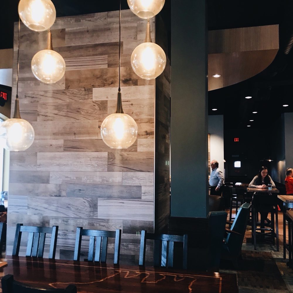 Caribou Coffee - a table and chairs in a restaurant - Coffee & Tea Near Me - White Bear Lake, Minnesota