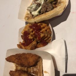 Chicken and waffle, waffle fries (I added the ketchup) and a Philly Cheesesteak.