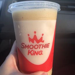 a hand holding a smoothie