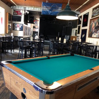 Union Street Station - Live music stage behind the floor seating, pool tables and DJ mic stand. - Music Venues Near Me - Traverse City, Michigan