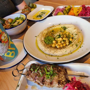 Bluto's - Lamb. Hummus. Tzatziki. Pickles. Sausage. Charred snap peas and squash. Bread. Some Wisconsin Lager I'd never heard of. - Greek Near Me - Portland, Oregon Bluto's - Lamb. Hummus. Tzatziki. Pickles. Sausage. Charred snap peas and squash. Bread. Some Wisconsin Lager I'd never heard of. - Greek Near Me - Portland, Oregon